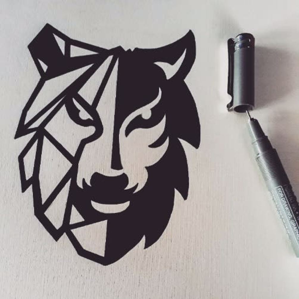 Drawn draft of a logo for a business. Logo is a wolf with one side shaded and the other side made from geometric lines.